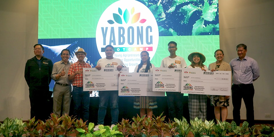 Standing (from left to right) are Dr. Joselito Florendo, Mr. Enrique Villaroman, Dr. Glenn Glegorio, Mr. Roberto Diala, Ms. Rocelle Lafrades, Mr. Mark Lee Babaran, Ms. Kristine Mae Baluzo, Dr. Mary Ann Sayoc, and Mr. Jose Marie Lopez during the awarding of the PHP 50,000 check.